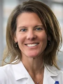 Dr. Debra Palazzi wearing her white coat